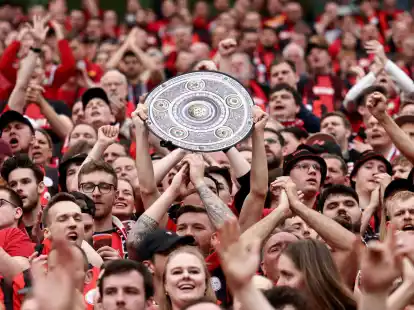 Fu&szlig;ball: Ein Leverkusener Fan h&auml;lt w&auml;hrend des Spiels eine Nachbildung der Meisterschale in den H&auml;nden. Bayer Leverkusen gewinnt die Deutsche Meisterschaft.