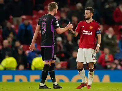 Uniteds Bruno Fernandes (r) und Bayerns Harry Kane geben sich nach einem Spiel die Hand.