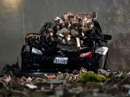 Ein Auto, das von herabfallenden Ziegeln einer umgestürzten Hauswand zerquetscht wurde, steht auf einem Parkplatz in der Innenstadt von Houston.