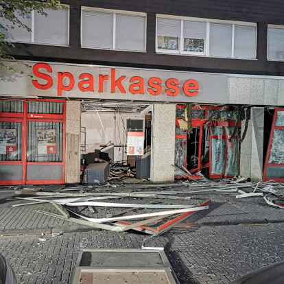 Trümmern von Fenstern und Fassadenteilen liegen nach einer Geldautomatensprengung vor einer Bankfiliale. In Niedersachsen geht die Zahl der Geldautomatensprengungen drastisch zurück.