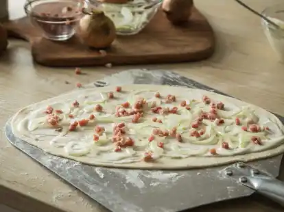 Der typische Els&auml;sser Flammkuchen wird mit Schmand, Speckw&uuml;rfel und Zwiebeln belegt. Ein Geheimtipp ist es, bereits in den Teig etwas wei&szlig;en Pfeffer zu geben.