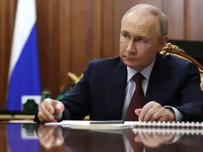 Der russische Präsident Wladimir Putin hört dem Präsidenten der Russischen Akademie der Wissenschaften, Krasnikow, während ihres Treffens im Kreml zu.